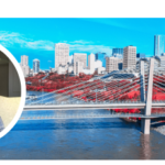 Eric Clark smiling with city skyline background